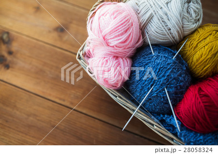 basket with knitting needles and balls of yarn basket with knitting needles and balls of yarn 28058324
