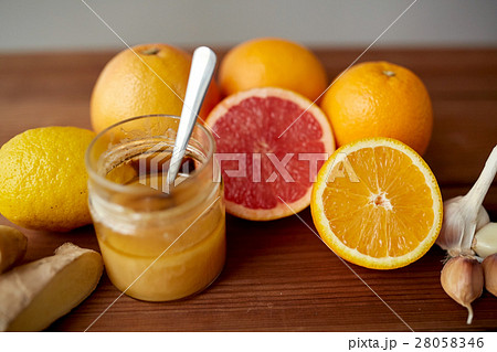 honey, citrus fruits, ginger and garlic on wood 28058346