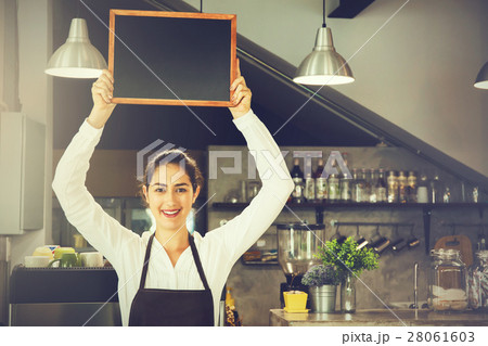 Beautiful Caucasian woman holding empty blackboard Beautiful Caucasian woman holding empty blackboard 28061603