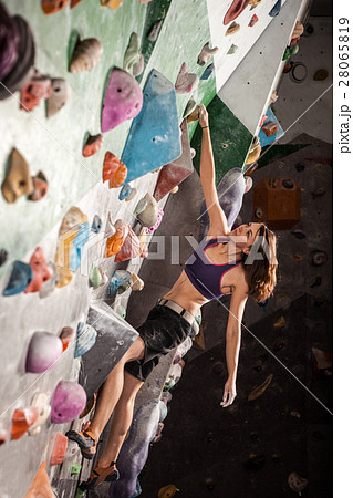 woman bouldering in climbing gym 28065819
