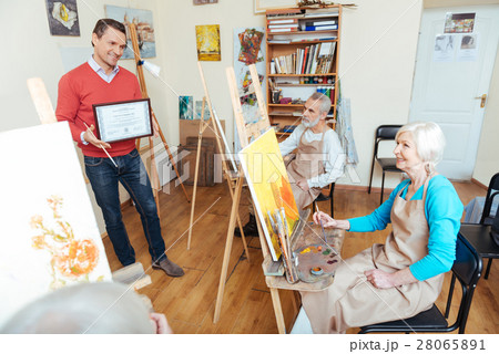 Handsome man demonstrating a painters diploma Handsome man demonstrating a painters diploma 28065891