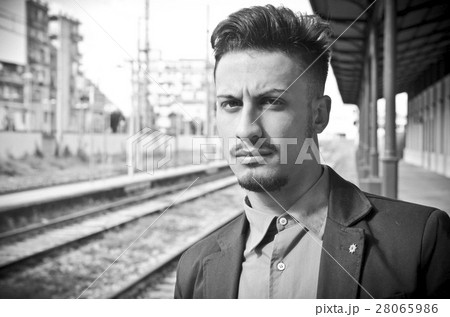 balck and white portrait of young man waiting at the train stat balck and white portrait of young man waiting at the train stat 28065986