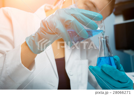 Woman spends experiments with flask Woman spends experiments with flask 28066271