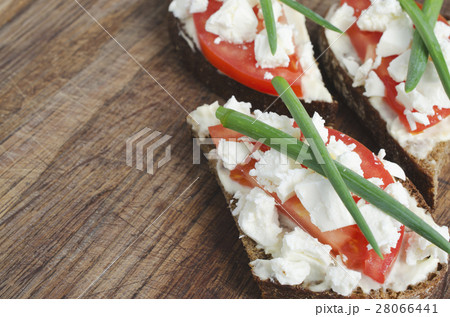 Slices of rye bread with sire feta and tomato. Slices of rye bread with sire feta and tomato. 28066441