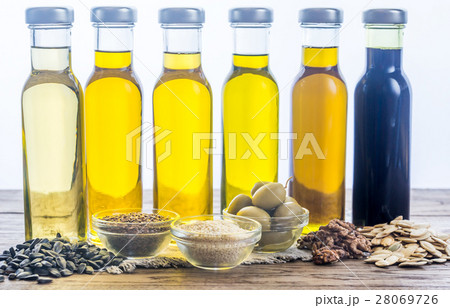 Bottles with different kinds of vegetable oil Bottles with different kinds of vegetable oil 28069726