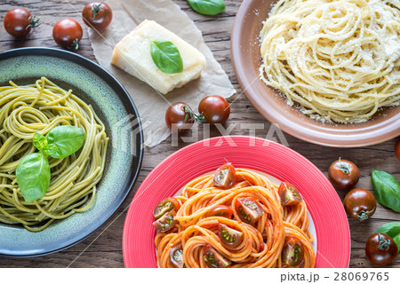 Portions of colorful spaghetti with ingredients 28069765