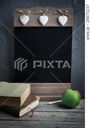 Old book and wooden blackboard 28073237