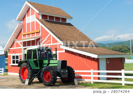 Green Tractor and Red Barn with blue sky and white Green Tractor and Red Barn with blue sky and white 28074264