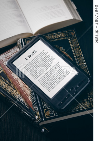 E-book reader device on desk in library 28075940