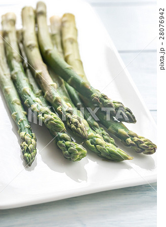 Bunch of cooked asparagus on the plate 28076942