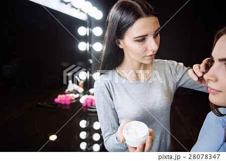 Attractive beautiful woman applying cream on her Attractive beautiful woman applying cream on her 28078347