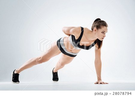 Concentrated girl standing in plank Concentrated girl standing in plank 28078794