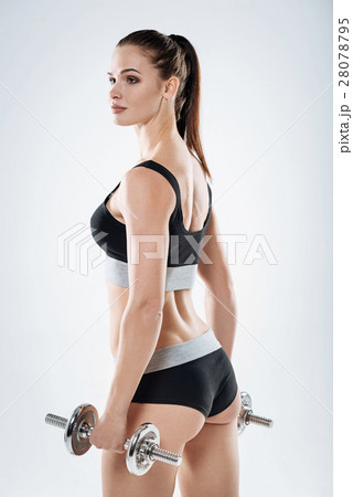 Inspired girl posing with dumbbells Inspired girl posing with dumbbells 28078795