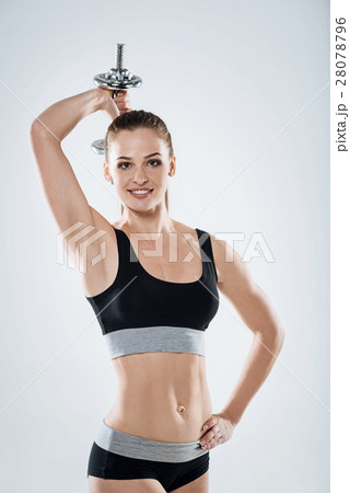 Smiling girl doing exercises with dumbbells 28078796