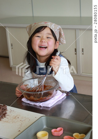 溶かしたチョコレートを混ぜる女の子の写真素材