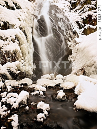 Frozen waterfall. Winter creek, icy rocky wall Frozen waterfall. Winter creek, icy rocky wall 28084274