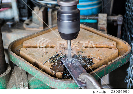 ndustrial technician working on a drilling machine 28084996