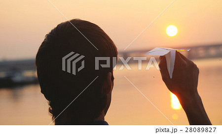 Silhouette of guy launch paper plane against the Silhouette of guy launch paper plane against the 28089827