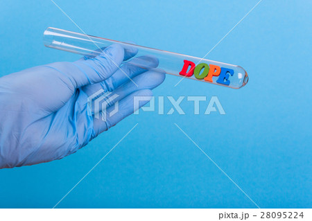 Word dope in test-tube holding a gloved hand Word dope in test-tube holding a gloved hand 28095224