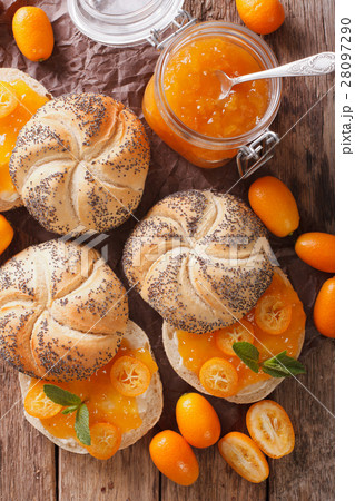 Kumquat jam in a glass jar and sweet sandwiches 28097290