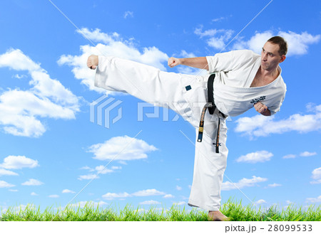 Karate master in kimono on blue sky 28099533