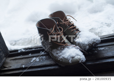 vintage leather shoes covered in snow by the door vintage leather shoes covered in snow by the door 28100935
