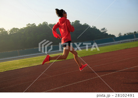 young fitness woman runner running on stadium track 28102491