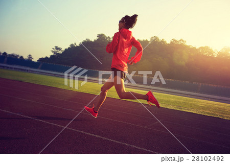 young fitness woman runner running on stadium track 28102492