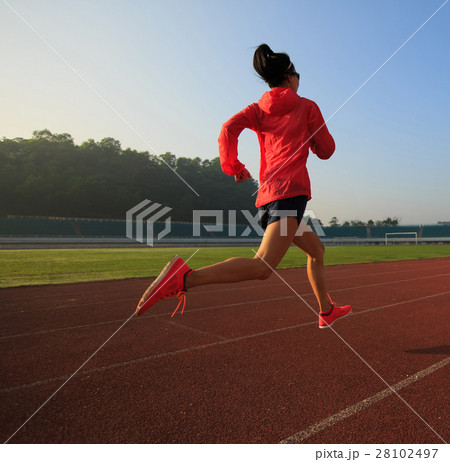young fitness woman runner running on stadium track 28102497