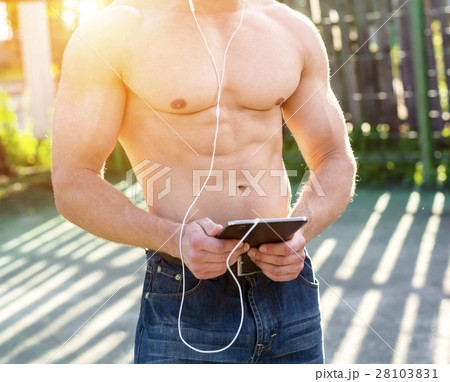 Athletic with a clipboard watching a movie Athletic with a clipboard watching a movie 28103831