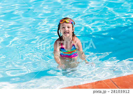 Child learning to swim in pool 28103912