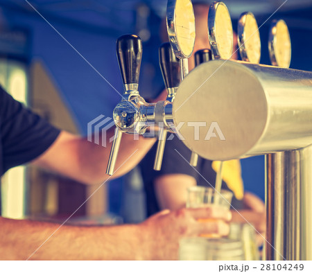 Draught draft beer taps in a bar . Vintage look Draught draft beer taps in a bar . Vintage look 28104249
