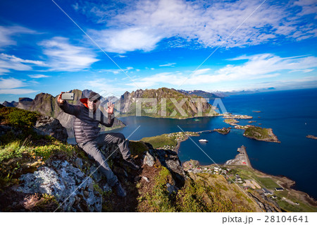 Man on top of a mountain taking a selfie Man on top of a mountain taking a selfie 28104641