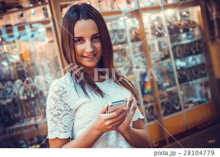 Girl holding a mobile phone Girl holding a mobile phone 28104779