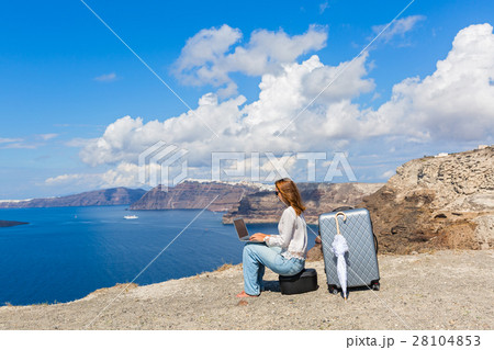 Young woman working on laptop on the seafront 28104853