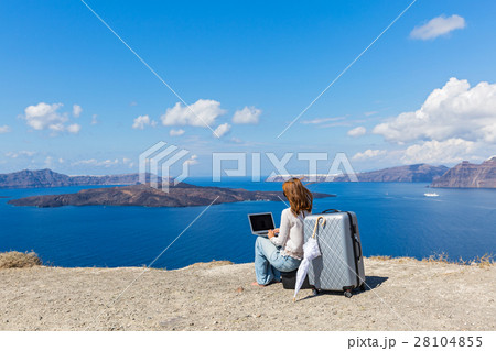 Young woman working on laptop on the seafront 28104855