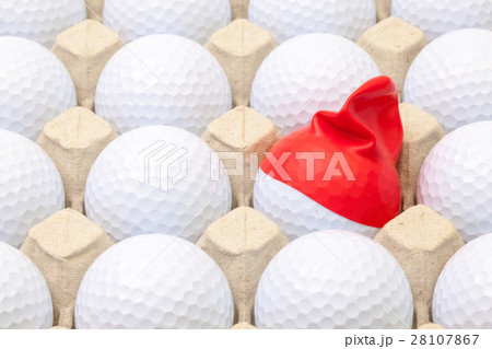 White golf balls in the box for eggs.  28107867