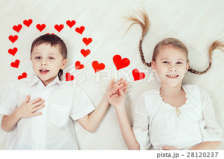 little boy and girl lying on the floor. 28120237