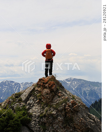 woman backpacker hiking on mountain peak cliff 28120921
