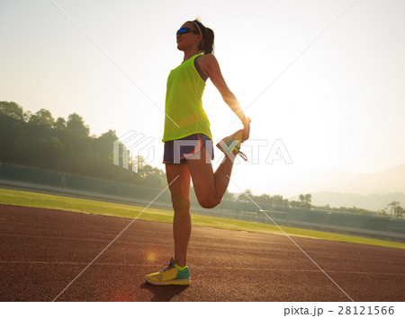 fitness woman runner stretching legs on track fitness woman runner stretching legs on track 28121566
