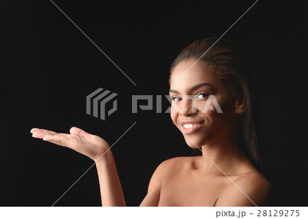 Happy african woman showing something interesting 28129275