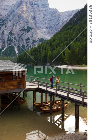 girls backpacker looking at Braies lake 28130386
