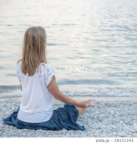 Woman meditating at the lake 28131343