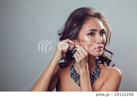 Young woman with make-up and styling tries on Young woman with make-up and styling tries on 28132206