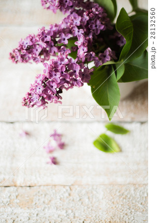Purple lilac bouquet laid on wooden table. Studio 28132560