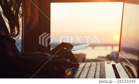 Woman using credit card online with her laptop on 28133245