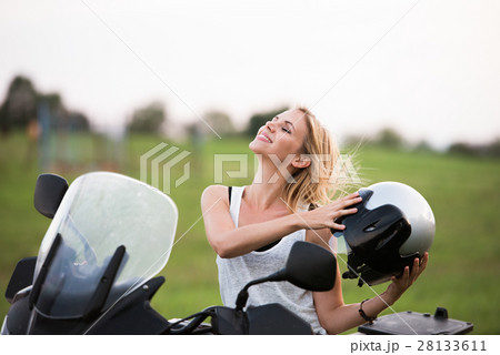 Pretty blond woman enjoying a motorbike ride in 28133611