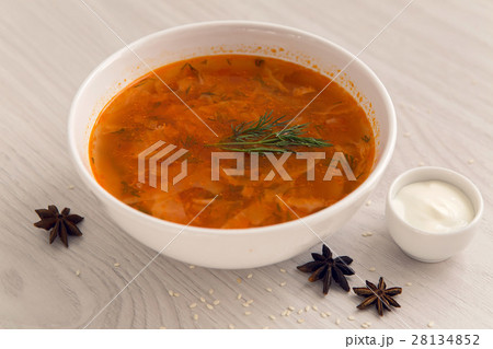 red soup in white plate on the table with sour 28134852