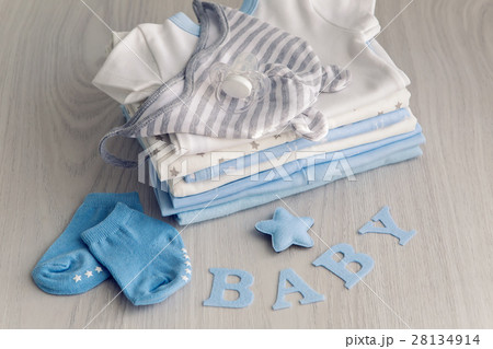 children's clothes with the diapers are stacked 28134914