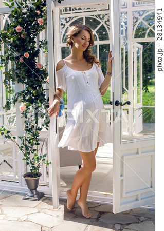 pregnant girl in a white dress on the street 28134941